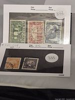 Five vintage Canadian stamps issued in 1927, mounted on paper with visible postmark cancellation marks.