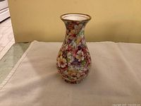 Front view of the James Kent Fenton Du Barry floral porcelain vase showing full shape, colorful floral pattern and gold trimmed rim.