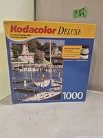 Front view of sealed Kodacolor Deluxe 1000-piece puzzle box showing the harbor scene image and product details.