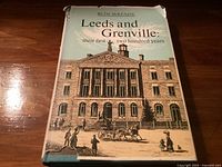 Front cover of book with dust jacket showing historical building and title.