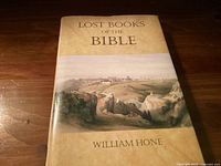 Front cover of the book titled 'Lost Books of the Bible' by William Hone showing the title and an illustrated landscape.