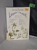 Front cover of Mark Twain's Library of Humor book with slipcover showing tear at bottom