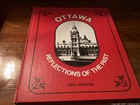 Front cover of the book showing the title 'Ottawa Reflections of the Past' and illustration of a Parliament building.