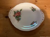 Top view of Paragon Rendezvous cake plate showing pink rose floral pattern and gold-edged handles.