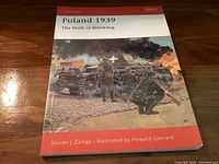 Front cover of Poland 1939 book showing illustrated wartime scene with soldiers and tank.