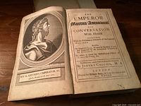Frontispiece and title page open showing portrait of Emperor Marcus Antoninus and publication details with 1701 date.