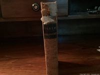 View of the book spine showing the title 'Jones Philosophy' with visible damage and wear, indicating antique condition.