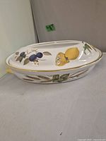 Top and side view of Royal Worcester Evesham covered vegetable dish showing lid design and gold trim