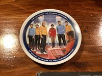 Front view of the Star Trek small commemorative plate showing six characters from the series with border text.
