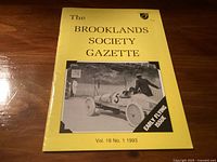 Yellow booklet titled 'The Brooklands Society Gazette' with a photo of a vintage racing car and driver on front cover, marked as early flying issue, Vol. 18 No. 1, 1993.