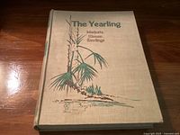 Front cover of the hardcover book The Yearling with title and author illustration