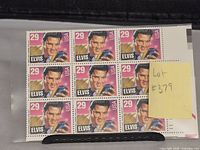 Front view of block of 9 USPS Elvis Presley 29¢ stamps, showing colorful portrait and denomination.
