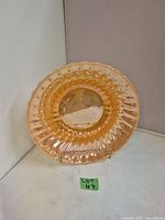 Top view of the peach lustre glass bowl showing the wavy scalloped edges and lustrous finish.