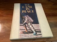 Front cover of 'We Came In Peace: The Story of Man in Space' book showing astronaut illustration and title