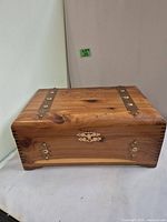 Closed wooden storage box showing copper hardware accents and wood grain