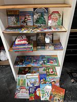 Full shelf view of assorted children's books focusing on Christmas themes.