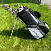 Full view of MacGregor stand bag loaded with left-handed clubs on grass