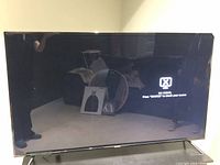 Front view of powered on Westinghouse 58 inch TV showing 'No Signal' message on screen.