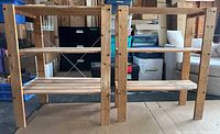 Larger and smaller wooden shelving units side by side, showing overall shape and condition.