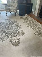 Full view of rug with chair and speakers showing overall pattern and layout