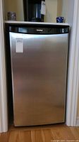 Front view of the Danby bar fridge showing brushed chrome door with black top panel and Danby branding.