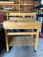 Front view of entire VegTrug potting bench stand showing upper and lower shelves