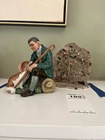 Photo showing both Royal Doulton figurine and granite clock side by side on surface