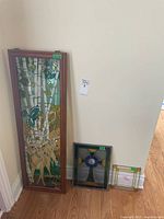 Wide view of the three stained glass panels showing size comparison and designs including deer and bird on large panel.