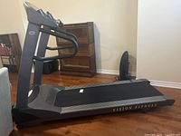 Side profile of treadmill showing deck, belt and side frame with Vision Fitness branding