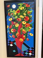 Full view of the colorful painting featuring an abstract bouquet in a red vase on a blue and geometric patterned background.