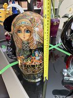 Photo of the large Russian nesting doll alongside a measuring tape showing about 13 inches height