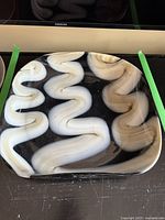 Full view of black rectangular Murano glass platter with bold white wavy design across the surface, showing size and glossy finish.