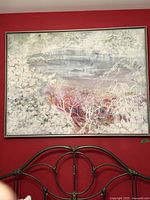 Full view of large framed oil painting on red wall, showing landscape with mixed abstract elements.