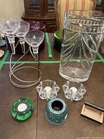 Photo showing Waterford Crystal vase and multiple candle holders including star-shaped, green round, and mosaic tile candle holders.