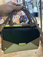 Front view showing multi-tone paneled design and gold clasp