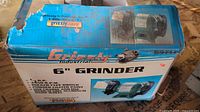Grizzly Industrial blue retail box showing product details and image of the 6-inch bench grinder.