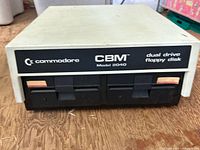 Front angled view of Commodore CBM 2040 dual drive floppy disk unit showing label and drives