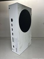 Side view showing the Ethernet, three USB ports, HDMI out on the back with scuff marks and wear.