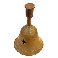 Front and side view of antique brass bell showing etched floral decoration at base and croce cutout on bell body.
