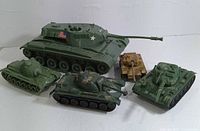 Photo showing all five assorted plastic military battle tanks in a group on white surface.