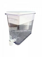 Clear plastic large rectangular water dispenser with white filter component inside, white lid on top, and white spigot at bottom front for dispensing water.