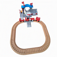 Full assembled play set on a white background showing wooden track forming a circuit with red rescue vehicles and grey-blue rescue station.