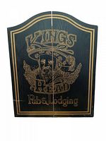 Front view of the closed wooden cabinet with King's Head Pub & Lodgings gold lettering and illustration.
