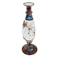 Photo of small handmade Egyptian perfume bottle showing front with blue and gold floral details.