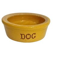 Side angle photo showing yellow stoneware bowl with brown DOG writing on side.