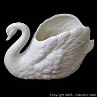Side view of the off-white bisque ceramic swan planter showcasing detailed feathers and matte texture.