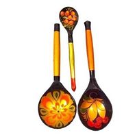 Front view of three Khokhloma hand-painted wooden spoons showing colorful red, gold, and orange floral and berry designs on black lacquer background and orange-yellow handles.