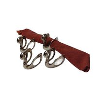 Four silver plated swan napkin holders displayed with one holding a cloth napkin, showing their shape and reflective finish.