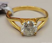 Close-up of the silver moissanite ring showing the 1.75 carat round stone and rhodium plated band