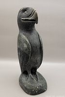 Front angle view of the carved eagle sculpture showing the stylized beak, wings and standing pose.